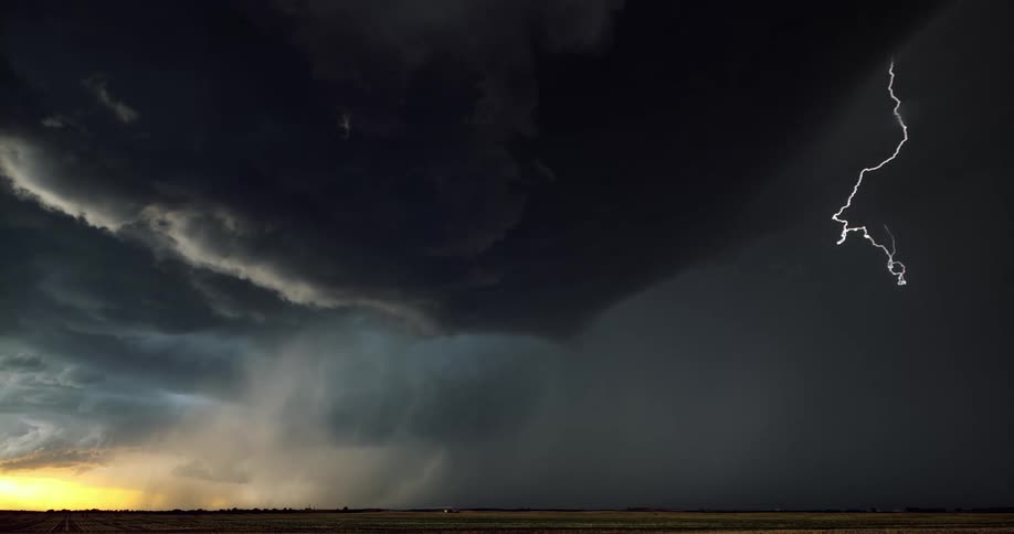 Lightning flashing in a sky with dark clouds during a thunderstorm