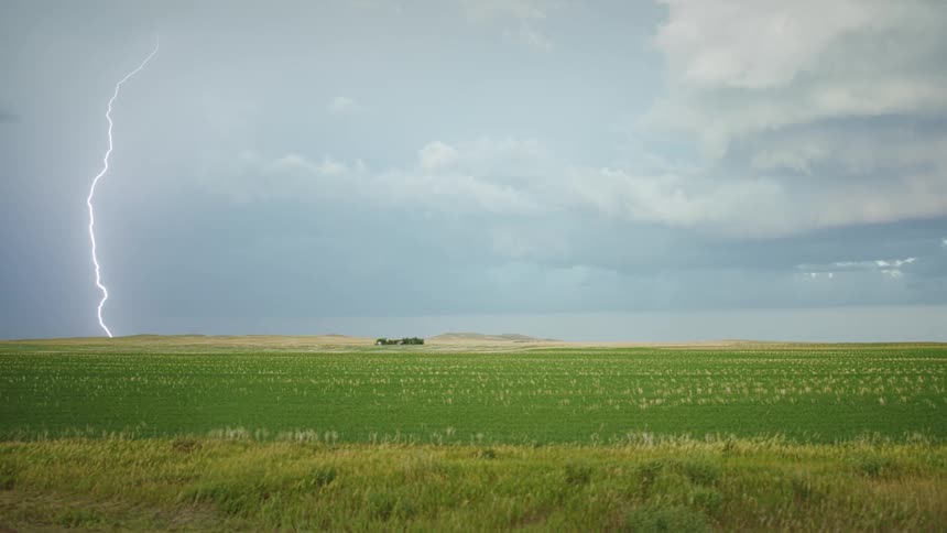 A slow motion view of lightning striking at a field
