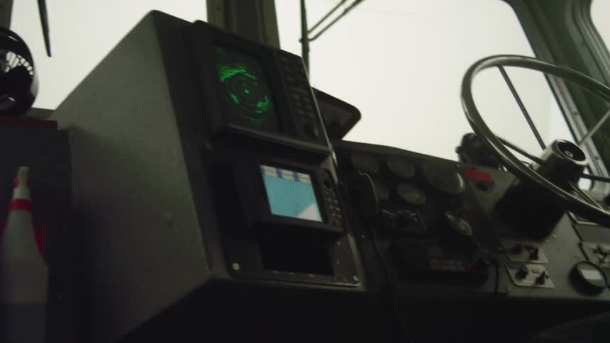 A steering wheel on the dashboard of a vehicle