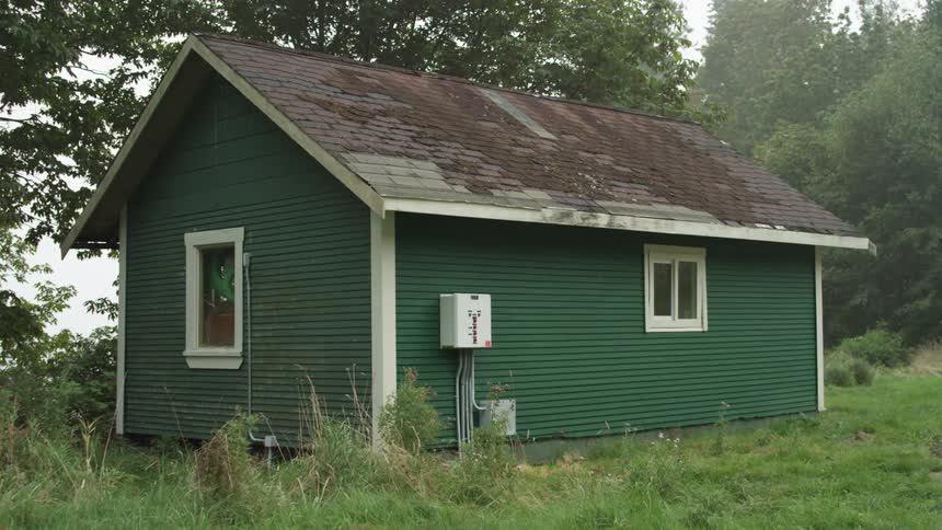 A house is in a rural area surrounded by trees