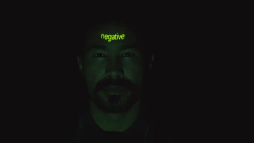 A light shining on a mans face in the dark