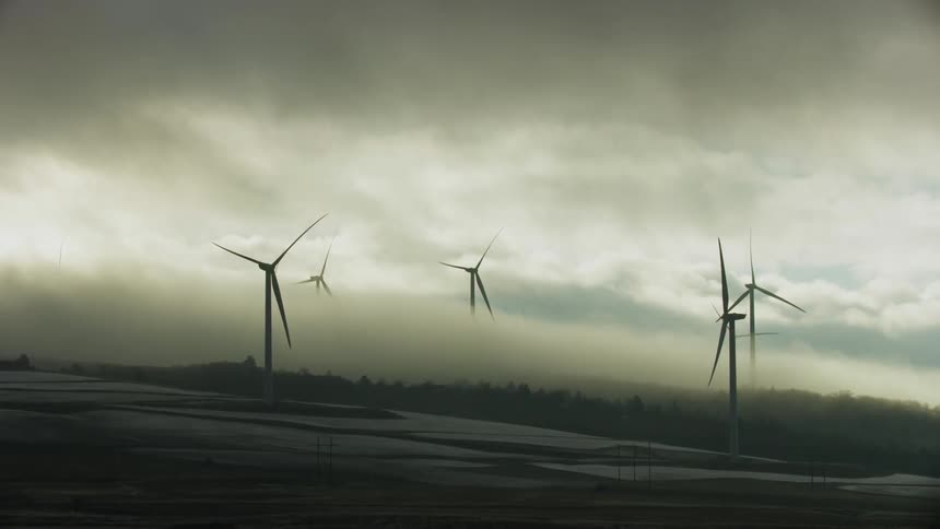 Freezing fog and frost prevent these wind mills from rotating on a frigid winter morning at a wind farm not creating electricity