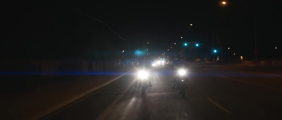 A view of people riding motorcycles down a street