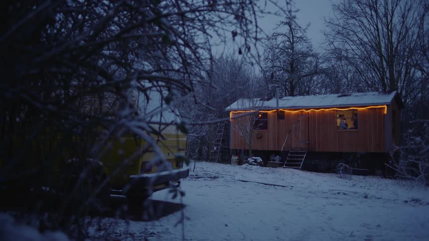 People are moving in the trailer across the snow