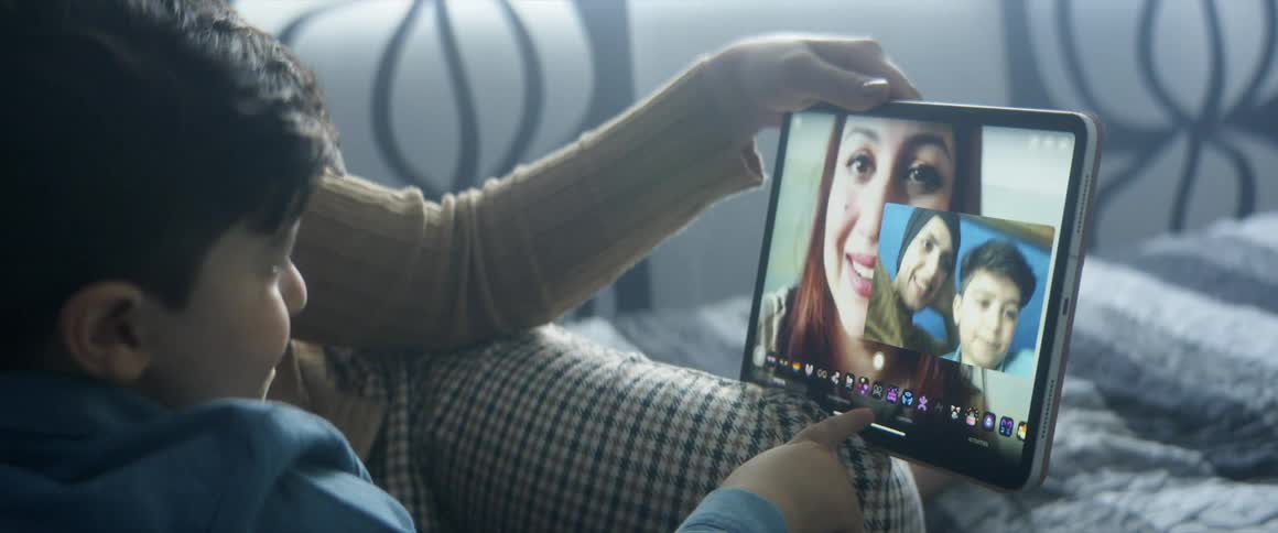 Mother and son making a video call relaxing in bed on the bedroom at home