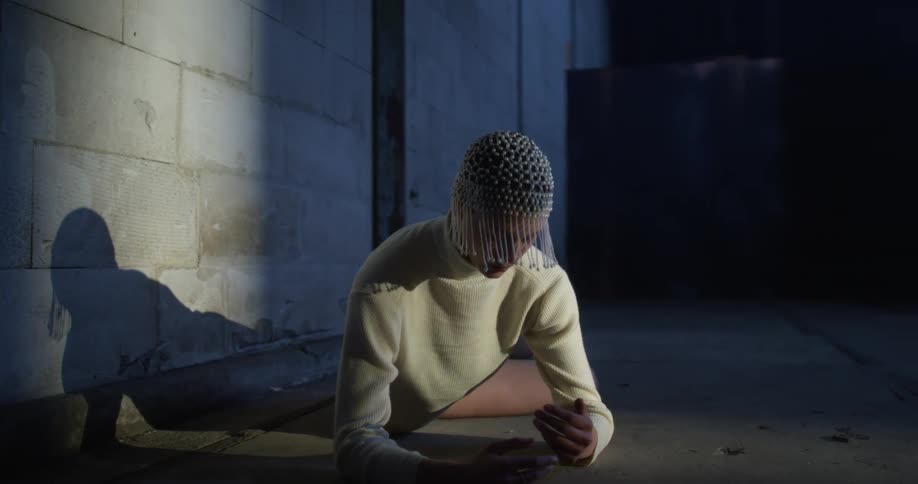 Woman perfoms modern dance movements on the floor of an empty building