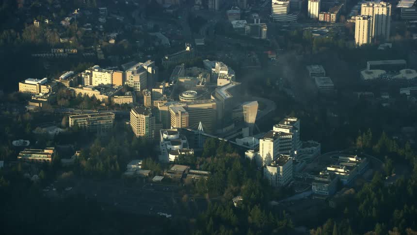 OHSU Hospital and university seen high above Portland Oregon as white wispy clouds pass by the aerial camera