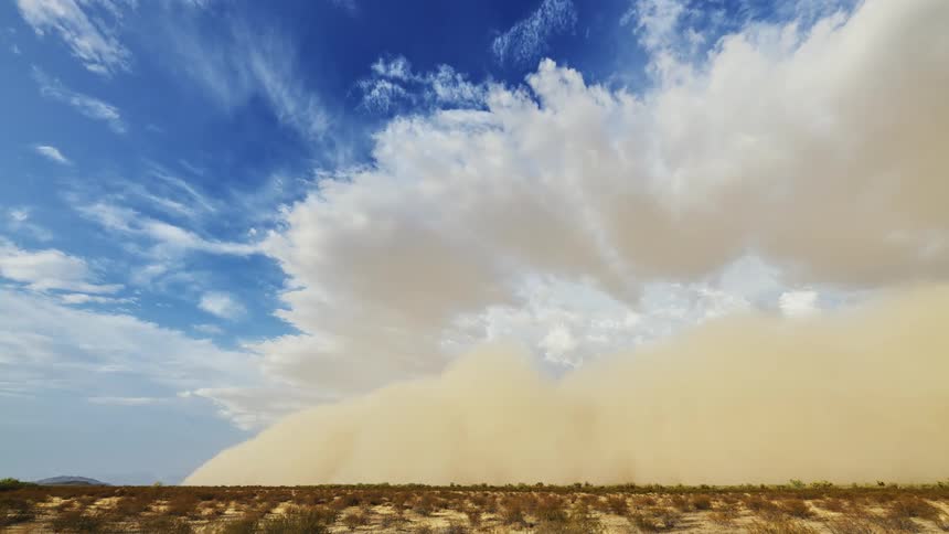 A sandstorm travels over the desert