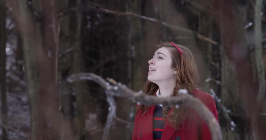 A woman enjoys a snowy winter day