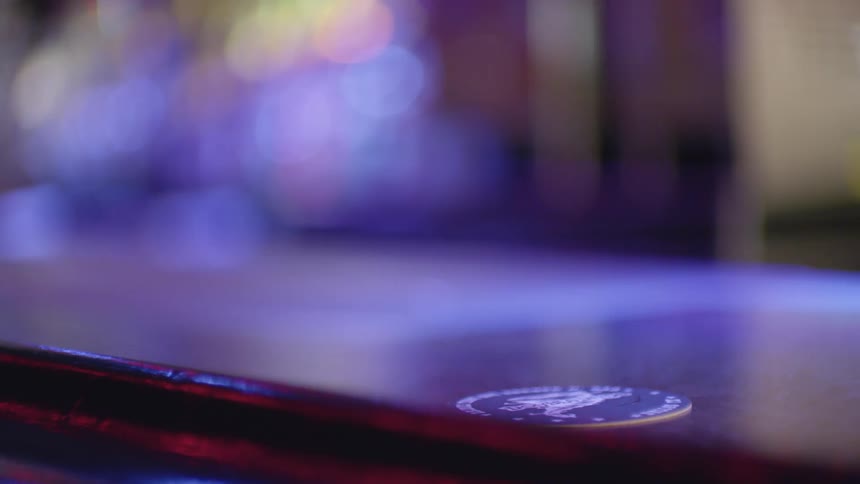 Picking up an empty beer glass from bar counter