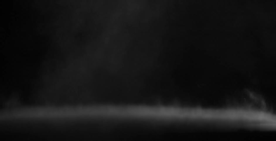 Surface covered in white dust vibrating on a black room