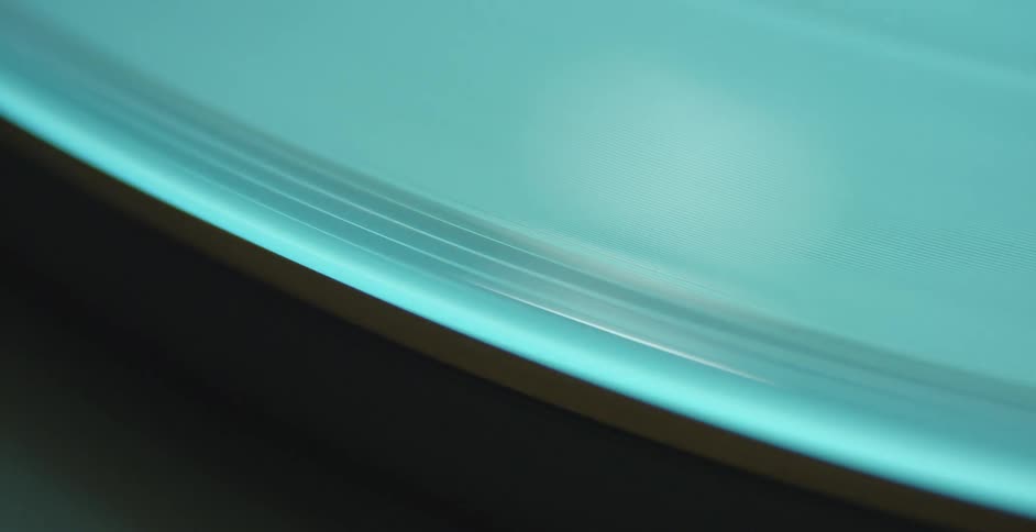 A turquoise plate spins rapidly on a centrifuge