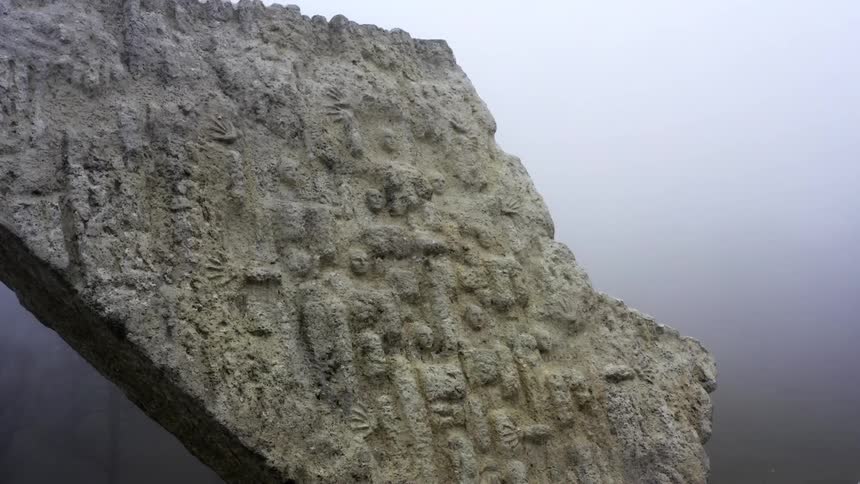 Heavy fog surrounds the stone