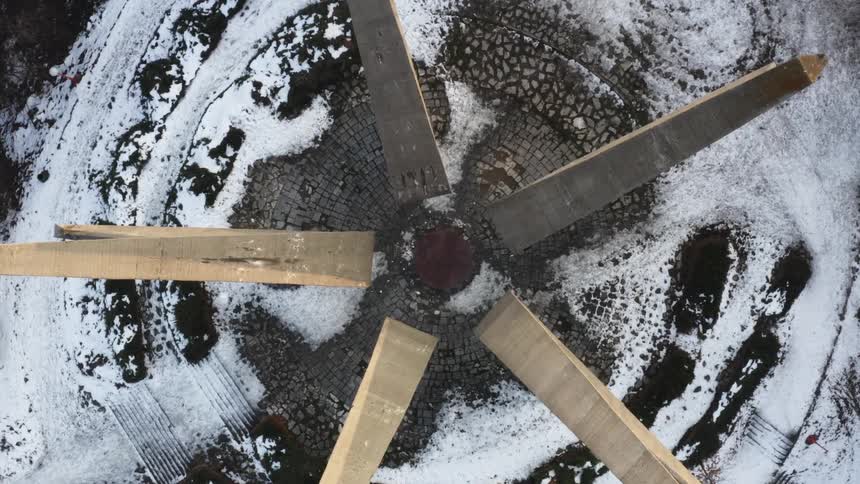 A sculpture made of concrete surrounded by snow