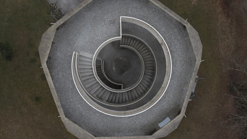 Aerial view of a spiral staircase inside a tower on the top of a hill