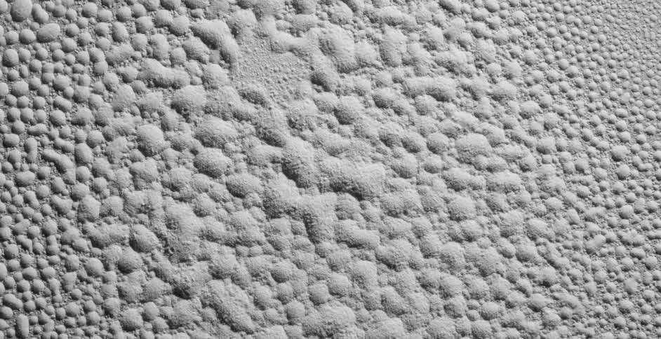 White powder repeatedly blows up and forms different patterns on the surface as the powder stands still