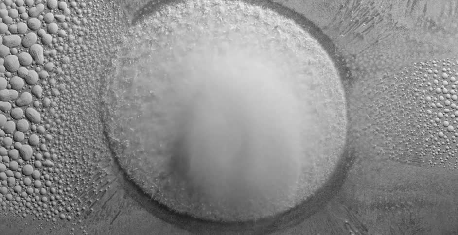 Powder jumps and shifts with vibration then settles into a bubble pattern