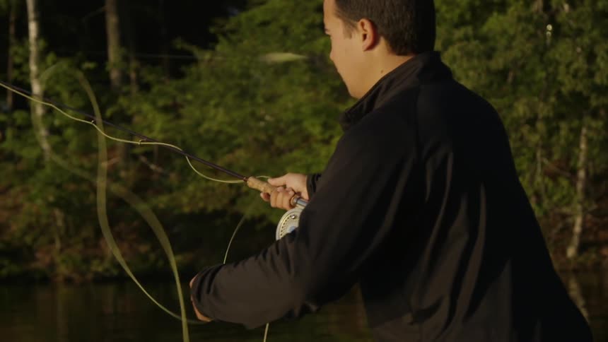 A man is fly fishing in the wilderness