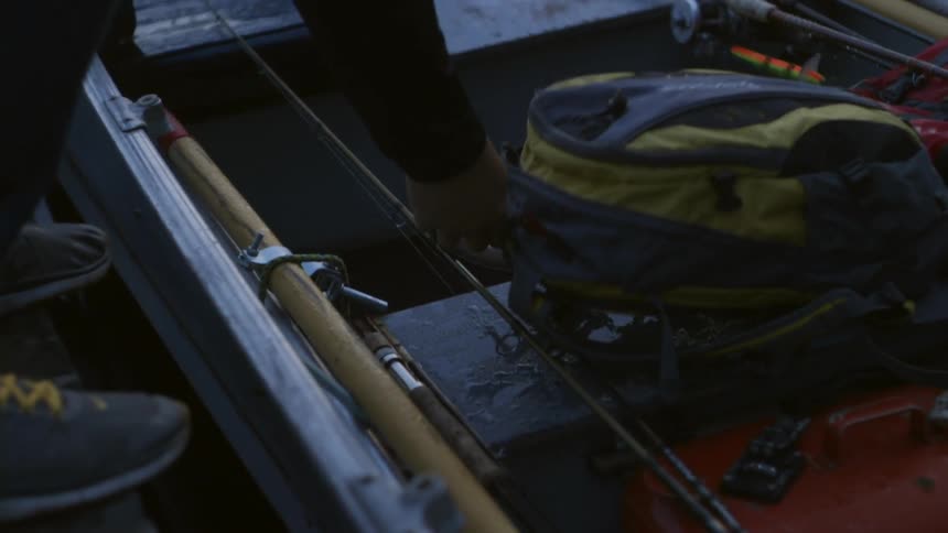 Someone laying a backpack on a boat seat