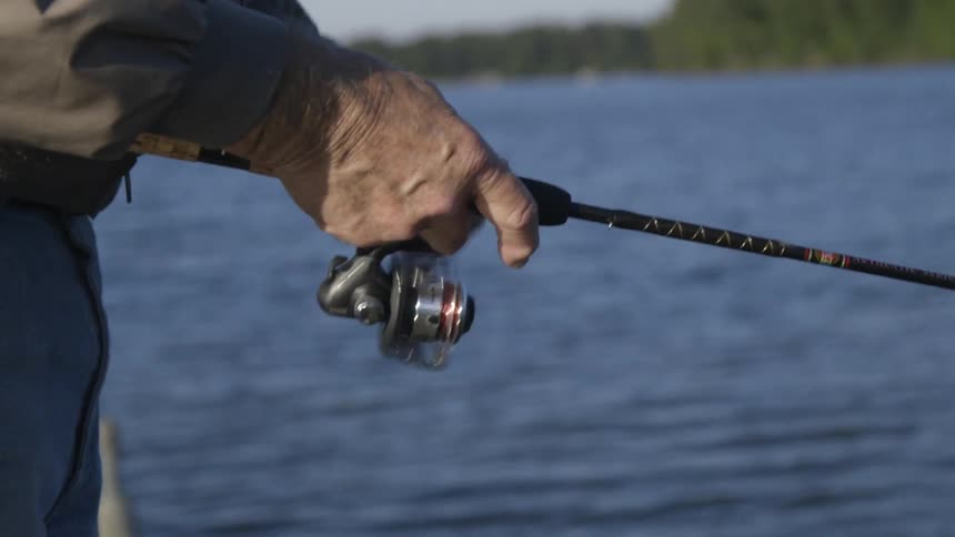A man is fishing winding in his line