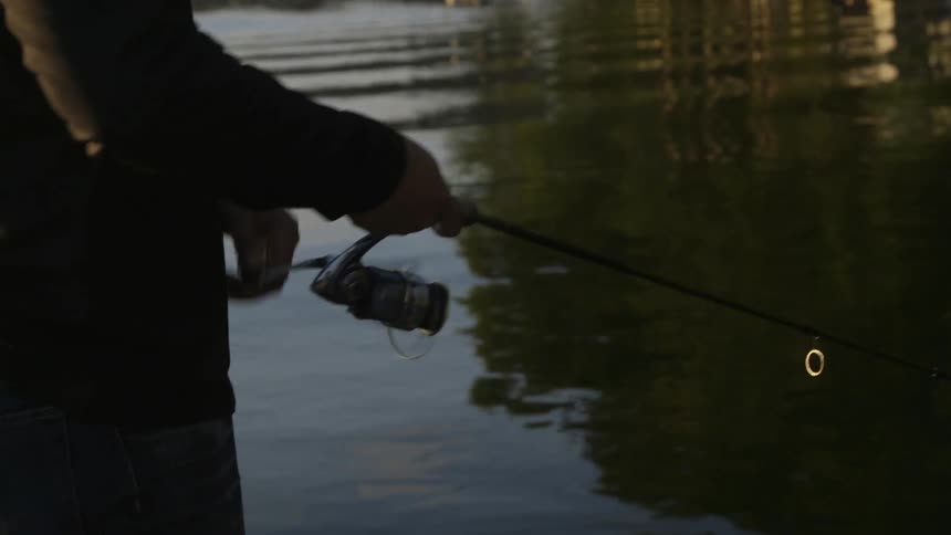 A man is using a rod and reel to fish
