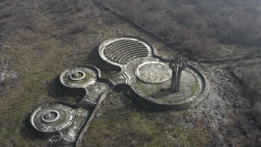 An aerial view of ruins in a field of grass