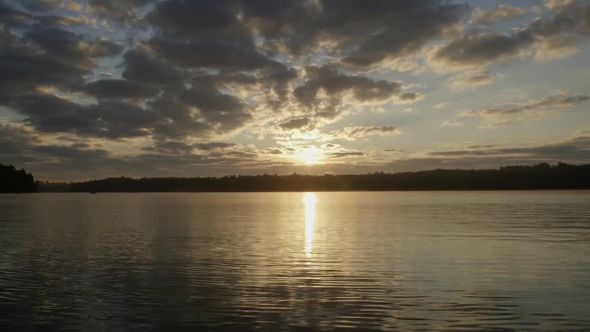 The water on a lake shimmering at sunrise