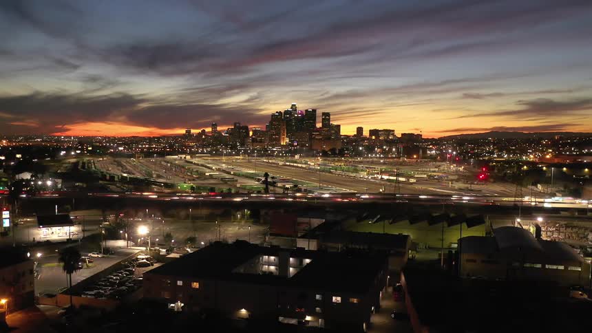 A time lapse of vehicles driving in front of a city skyline