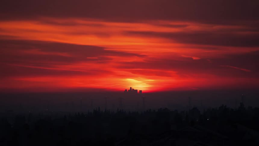 A time lapse of a sun setting on a cloudy day