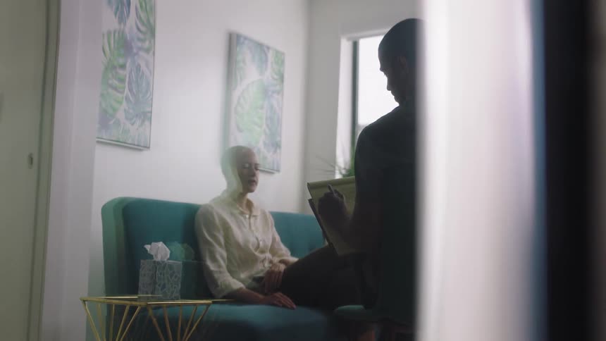 A man and woman talking to each other in a room
