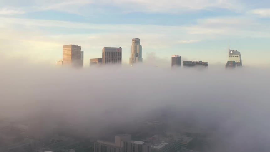 Aerial view of gray air pollution above a large city with high rise buildings at daytime