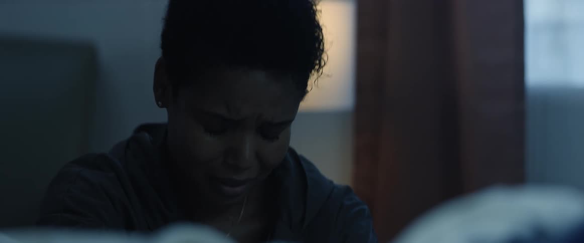 A woman is crying in the dark room