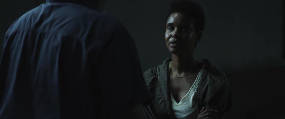 Man consoles and hugs a scared crying woman in the street of a city at night