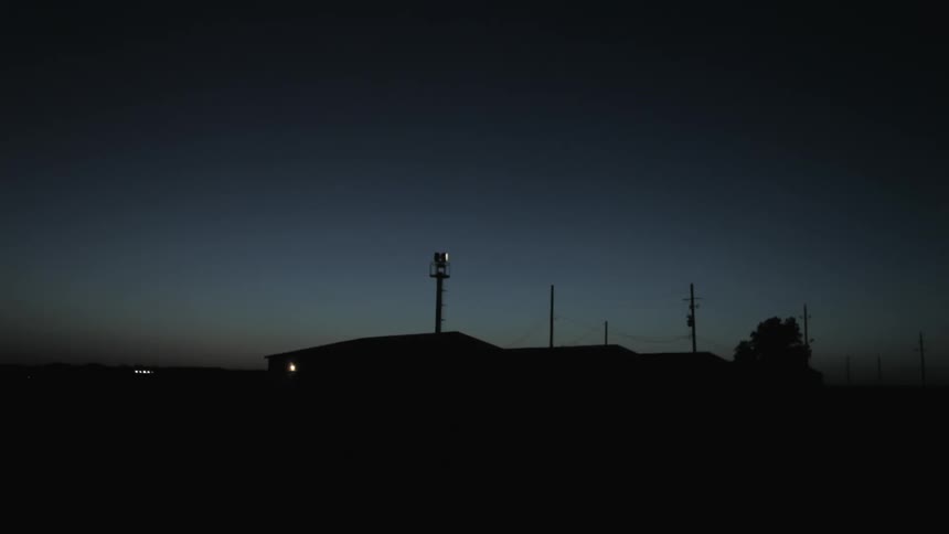 A beacon of light rotates in the night sky