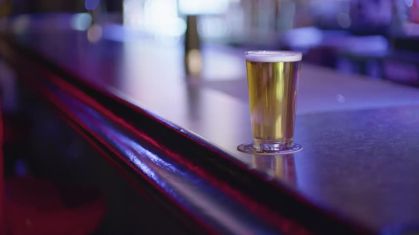 Full beer glass on a bar counter