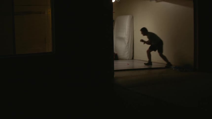 A man wrestling indoors