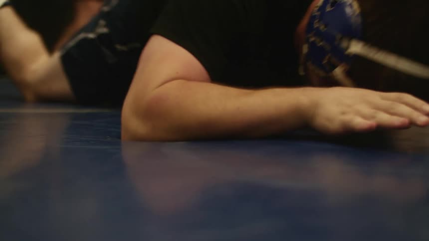 Two men in the gym wrestling