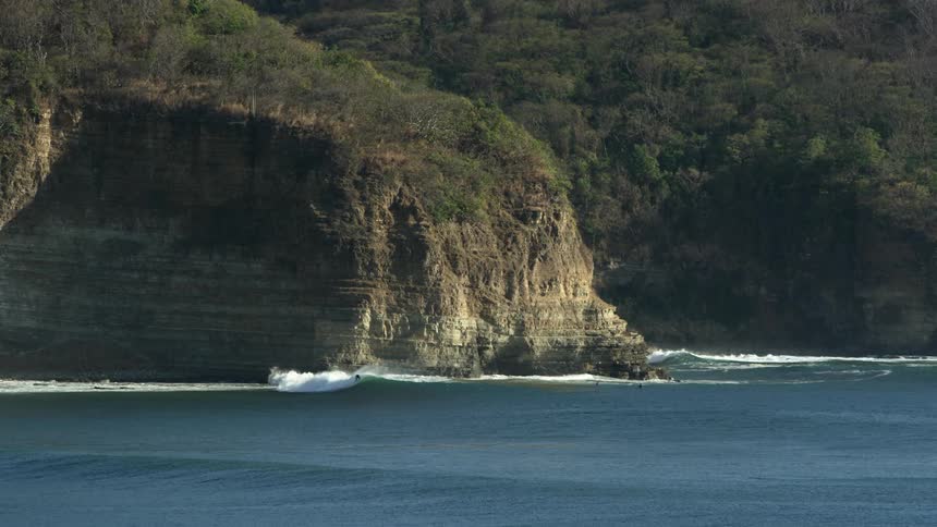 A view of waves crashing against cliffs on the ocean