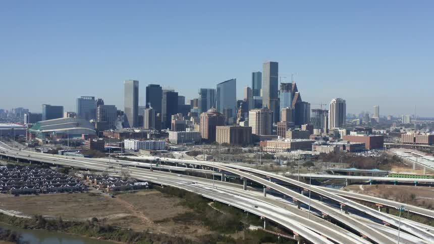Aerial view of the Houston skyline with tall buildings and highways