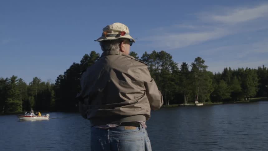 An older man fishing during the day