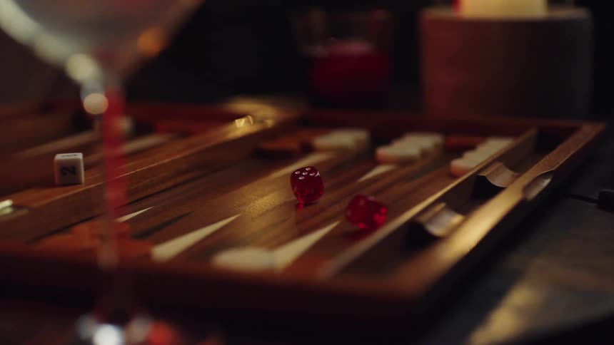 A person rolls dice on to a game while playing