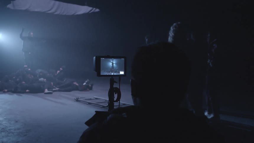 Actors performing a scene in a studio for a filmmaker