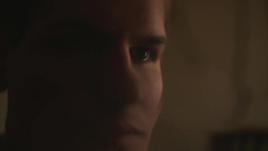 A man looks at himself in a mirror and walks away to reveal the mirror is shattered