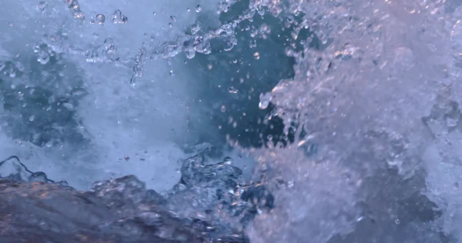 Awesome green blue and purple hues reflect of sandstone canyon walls in this slow motion cascading water creek shot