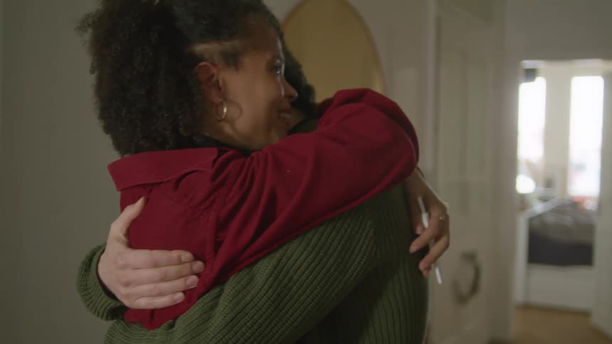 Young couple hugging in the hallway of a house