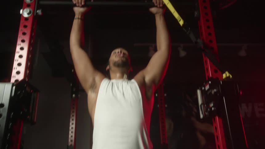 Strong muscular man excercising on a gym