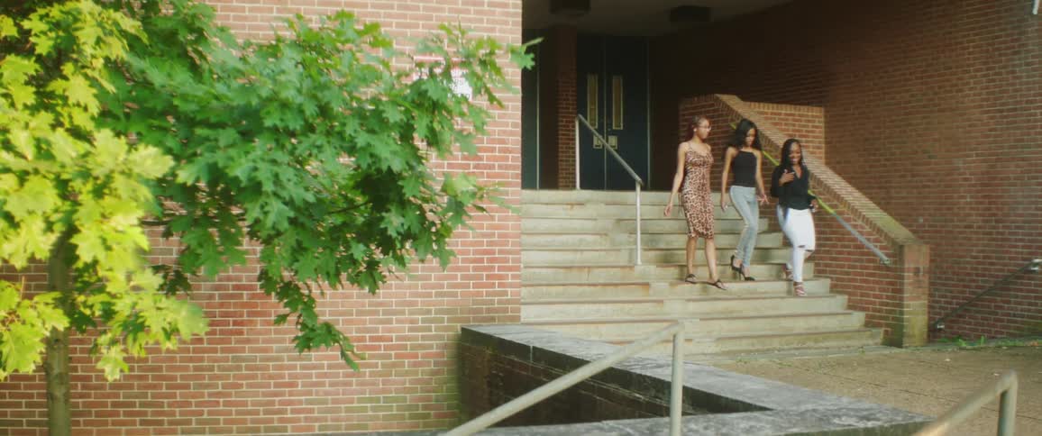 A group of three women walking down a staircase
