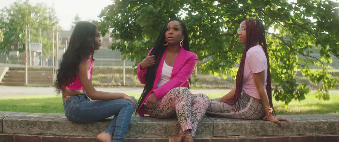 A group of women sitting around outside talking