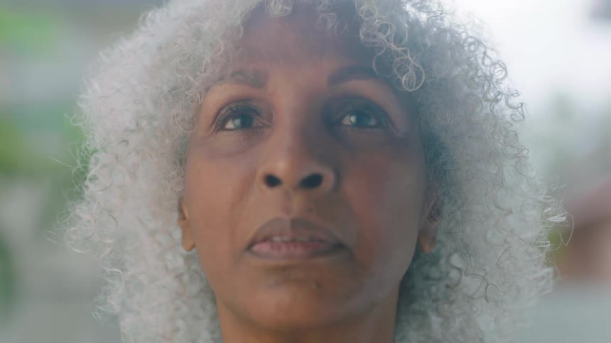 A woman takes a deep breath and slowly opens her eyes