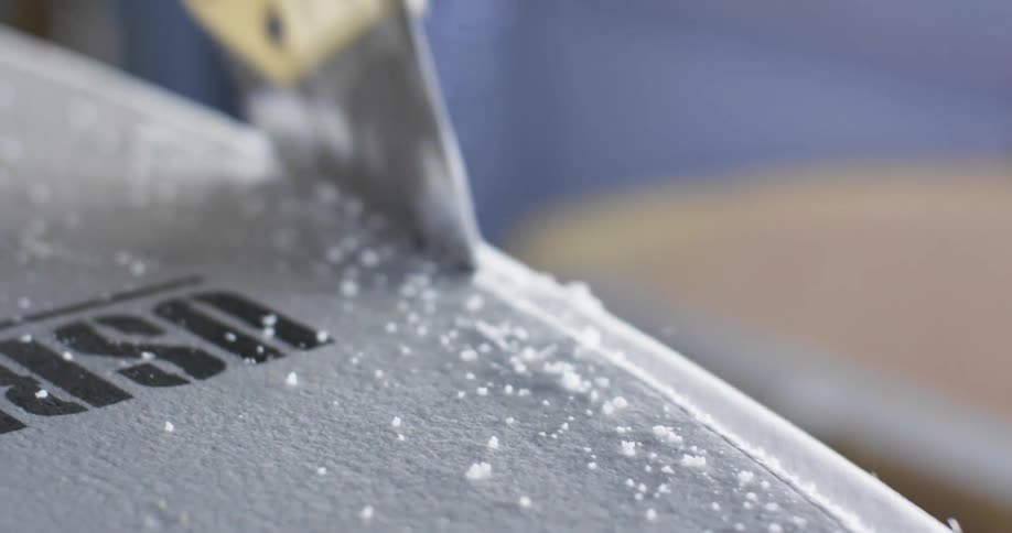 A saw cutting the core of a surfboard
